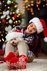 young girl holding a Christmas present puppy dog.