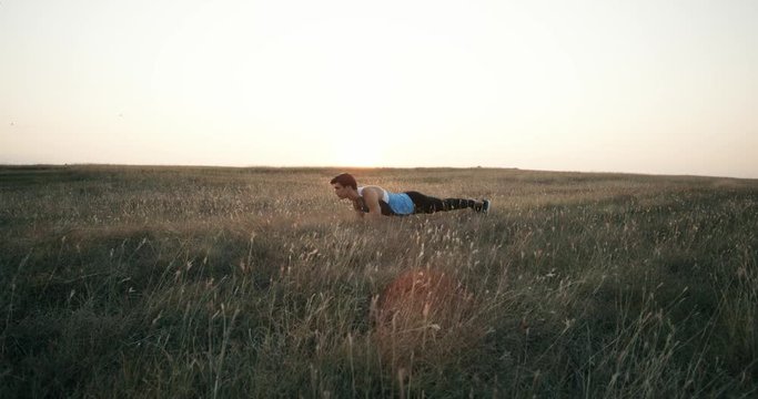 Silhouette of yoga sportsmen performs exercise at morning park