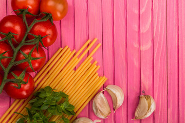 Italian Cooking Ingredients Including Pasta Spaghetti Garlic and Vine Tomatoes