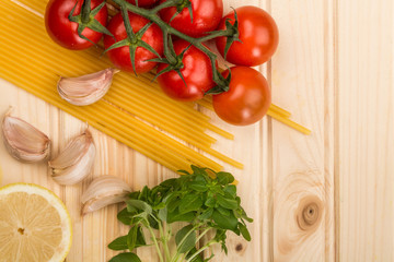 Italian Cooking Ingredients Including Pasta Spaghetti Garlic and Vine Tomatoes