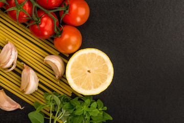 Italian Cooking Ingredients Including Pasta Spaghetti Garlic and Vine Tomatoes