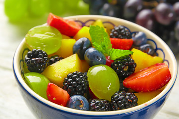 Bowl with delicious fruit salad, closeup