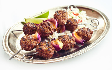 Roasted meatballs with rice on metal plate