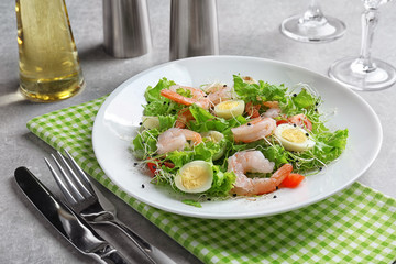 Plate with fresh tasty shrimp salad on table