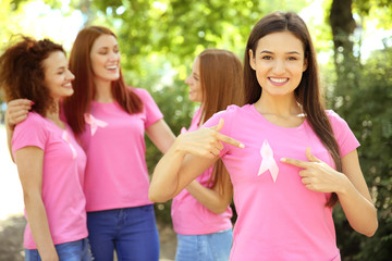 Fototapeta na wymiar Young woman in pink t-shirt outdoors. Breast cancer awareness concept