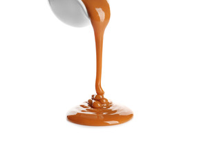 Delicious caramel sauce pouring on white background