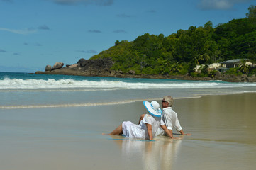 couple sitting  on  tropical beach