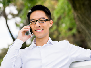 Businessman portrait with mobile phone outdoors