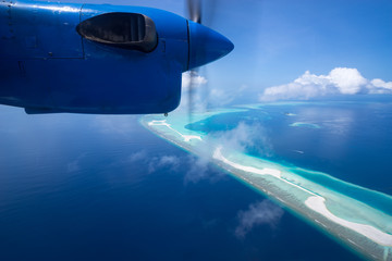 Naklejka na ściany i meble Aerial View from seaplane window over Atolls at Indian Ocean Maldives