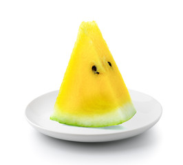 freah yellow watermelonin a plate isolated on a white background