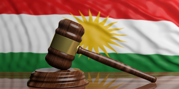The waving Kurdistan flag behind wooden and gold auction or justice gavel. 3d illustration