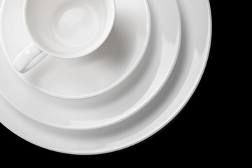 white clean dishes is piled in a stack on a black background.beautiful abstract background