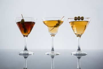 Cocktail with olives on table