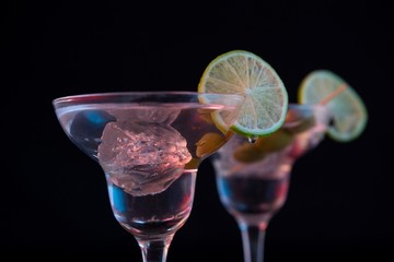Cocktail martini with olives and lime on table