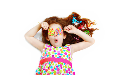 Surprised funny girl  hold candy lollipop on eyes.