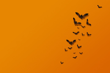 Halloween and decoration concept. Bats flying made from wood on orange brick wall