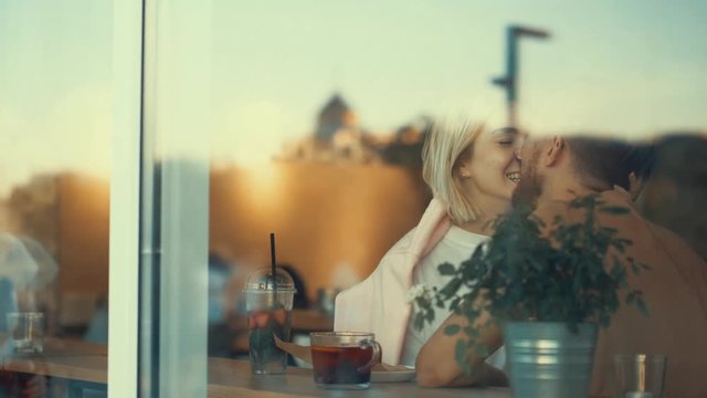 Kissing couple in a cafe