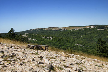 Old wooden bench near the coast of a mountain lake, Krimea