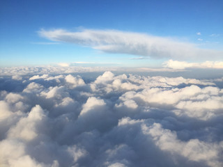 Naklejka na ściany i meble Sunny sky above the cloud from the plane