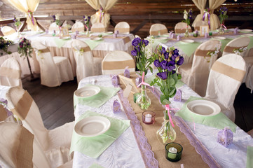 Beautifully decorated table for the wedding ceremony. Served banquet table decorated with fresh flowers in the open air