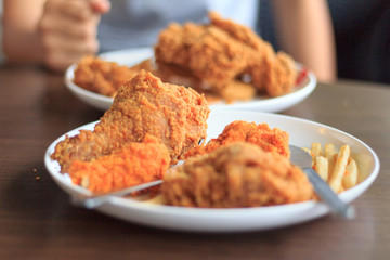 Fried chicken fried potatoes on a white plate select focus, Fried chicken fried potatoes on table Blured or blur soft focus