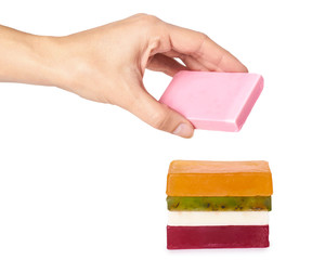 natural handmade soap bar in hand isolated on white background