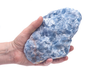  Woman's hand holding raw blue calcite cluster isolated on white background