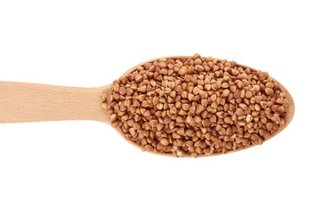 healthy buckwheat grains in wooden spoon isolated on white background