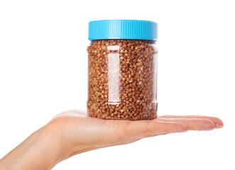healthy buckwheat grains in hand isolated on white background