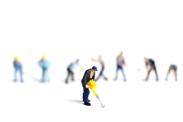 Miniature people worker holding tool on white background, construction concept