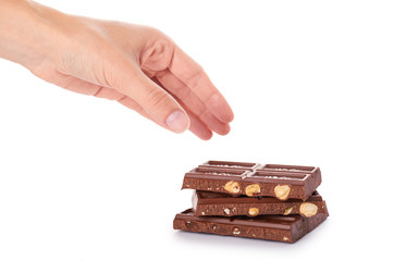 chocolate bar with nuts in hand isolated on white background