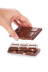 chocolate bar with nuts in hand isolated on white background