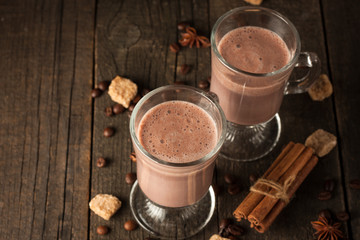 Chocolate, coffee, milk, banana shake on wooden background. Smoothie with cookies. Milkshake. Protein diet. Healthy food concept.