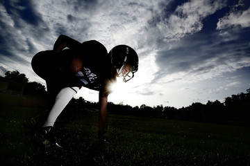 The American football player took up a position on the field.