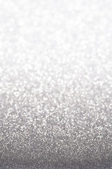 Silver (gray) glitter background. Sparkle texture. Abstract gradient background blurred for New...