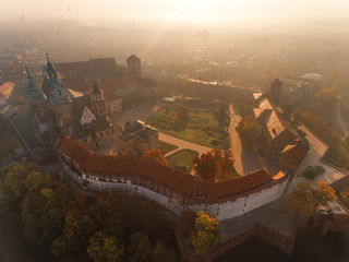 Fototapeta na wymiar Drone aerial view of Cracow and royal Castle in city center with morning fog, Vistula river. Krakow, Poland 