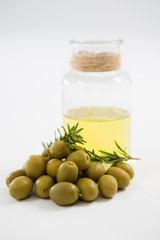 Marinated olives with oil bottle and herb