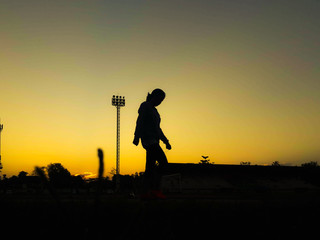 Silhouette teen age run together  track.