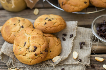 Peanut butter cookies with chocolate chips on wooden background