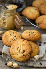Peanut butter cookies with chocolate chips on wooden background