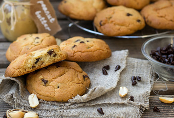 Peanut butter cookies with chocolate chips on wooden background