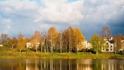 Fototapeta na wymiar Rural autumn landscape on a lake on a Sunny day. Russia. The ancient town of Gatchina. Autumn 2017.