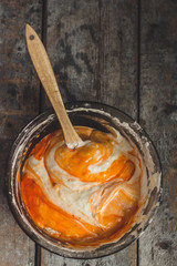 orange dough in the form for baking (pumpkin, carrots, flour, etc.)