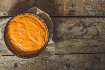 orange dough in the form for baking (pumpkin, carrots, flour, etc.)