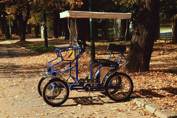 Fototapeta na wymiar Blue family bicycle in famous Vilson's promenade in Sarajevo , Bosnia and Herzegovina