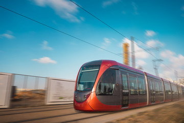 tram on railway in the city against sky 