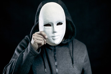Man holding white mask for hide his face