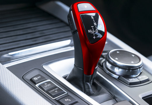  Red Automatic gear stick of a modern car, car interior details, close up