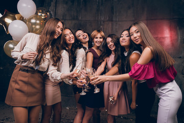 Beautiful girlfriends looking at the camera and smiling. Celebrate Christmas Ewe in the club with friends. New Year holiday with best friends.