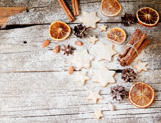 Christmas gingerbread cookies stars on a wooden table and cookie cutters, selective focus